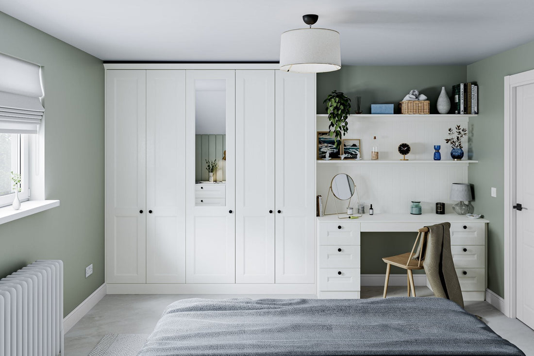 Pale beaded-panel fitted wardrobes beside a bay window seat
