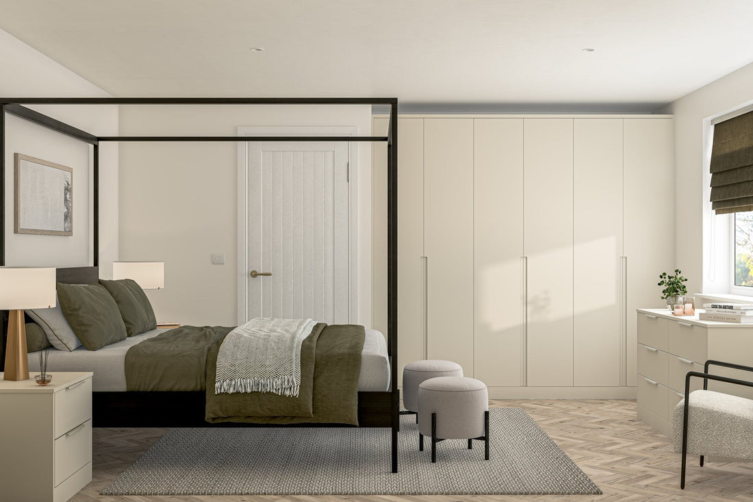 Taupe handleless fitted wardrobes behind a four-poster bed