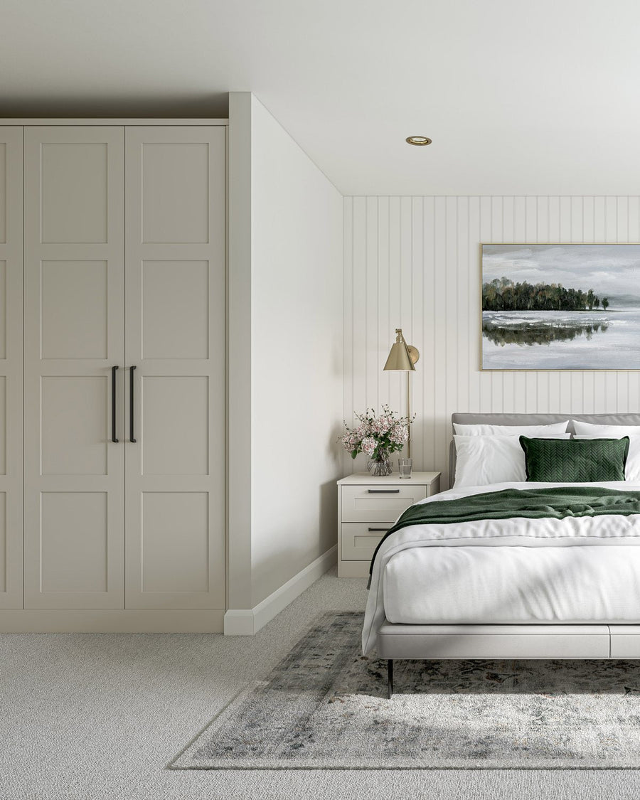 White narrow-frame Shaker fitted wardrobes beside a bed
