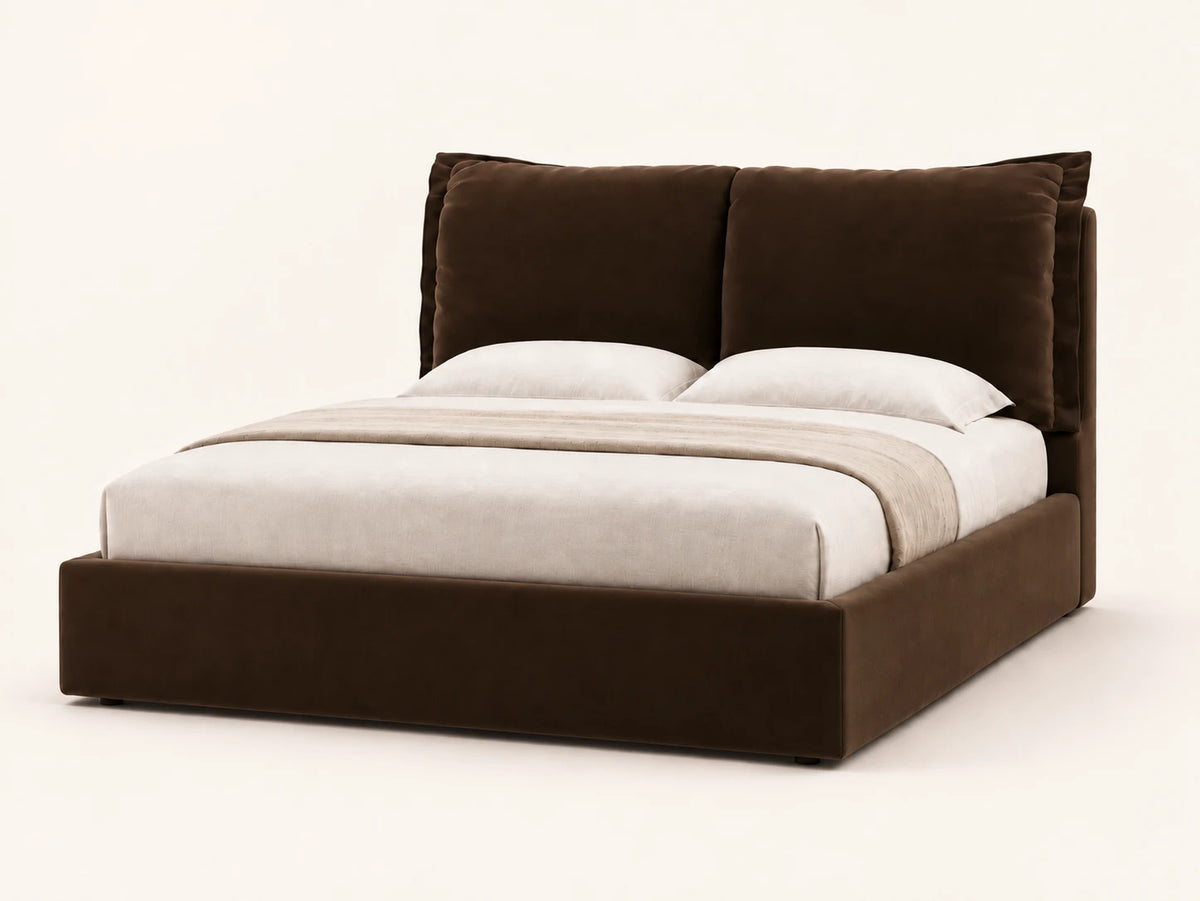 Pillow Headboard Bed in chocolate velvet, three-quarter view, two stitched cushion headboard panels on a low upholstered base