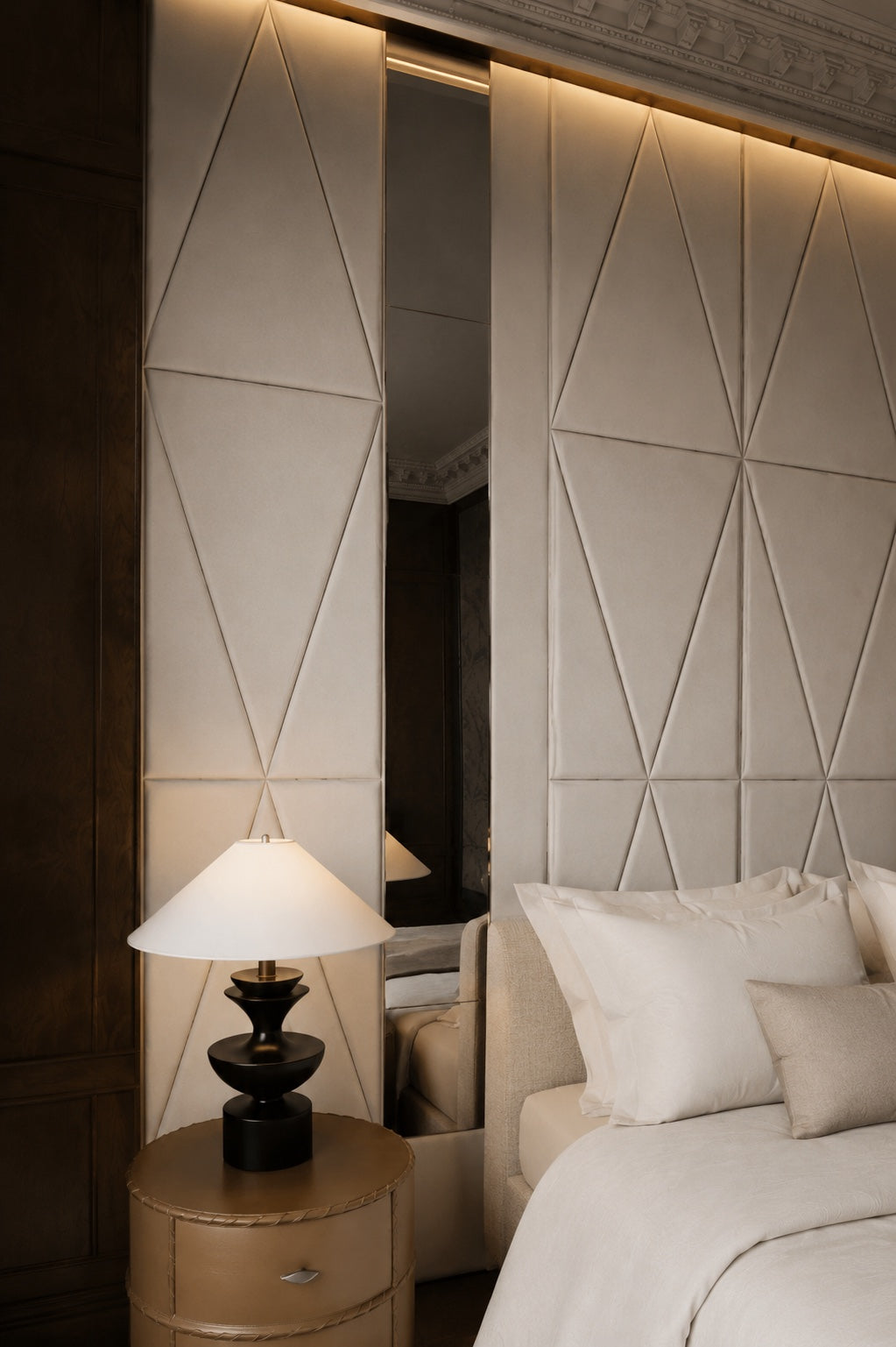 Full-height upholstered headboard wall with diamond panels, integrated mirror and lighting