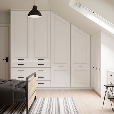 Angled wardrobe doors following the slope of the roof