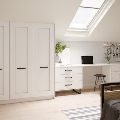 A desk and wardrobes fitted into a roof space