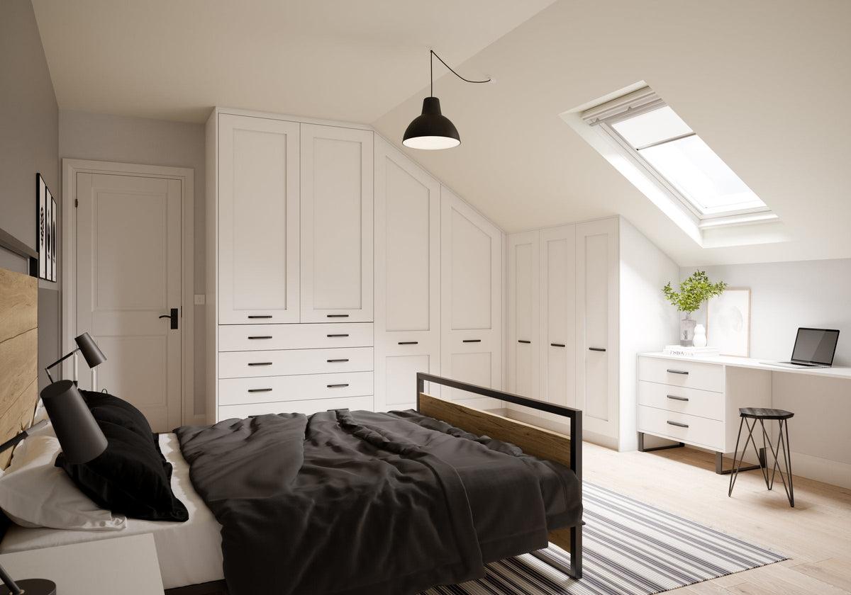 Fitted wardrobes with angled doors under a sloping bedroom ceiling