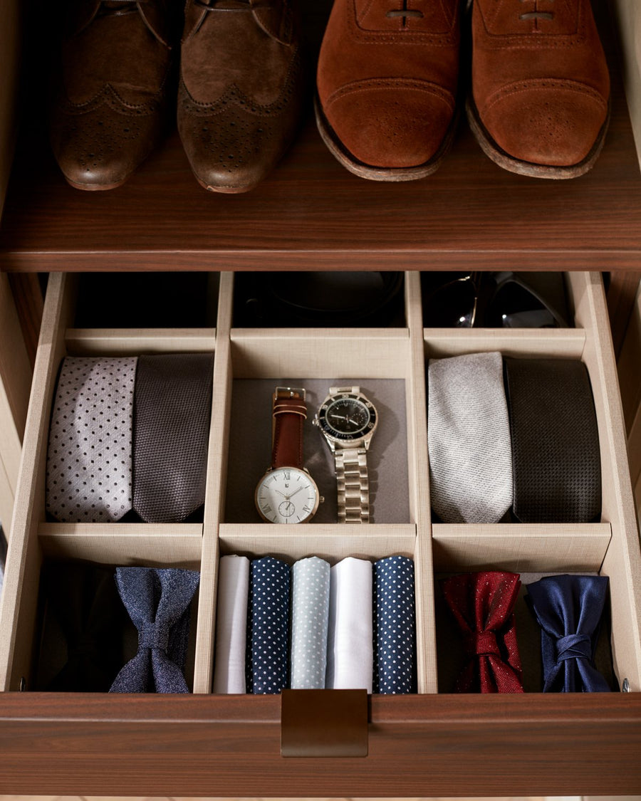 Walk-in wardrobe detail: shoes, ties and watches in walnut compartments